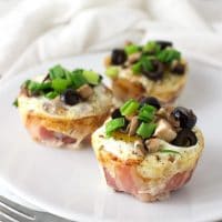 Three Bacon and Egg Muffins topped with green onion, olives, and mushrooms from acleanplate.com